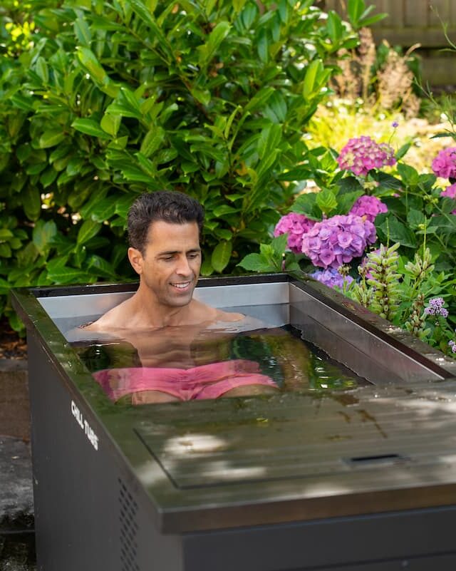 A man enjoying a Chill Tub ice bath in a Liverpool garden.